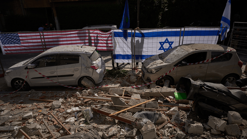 Israel Iran USA
Israeli authorities hang Israeli and U.S. flags at the site struck by an Iranian missile that killed two people, in Ramat Gan, Israel, Wednesday, March 18, 2026. 