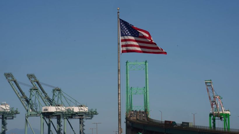 CORRECTS NAME OF BRIDGE - An American flag flies over the Vincent Thomas Bridge, Wednesday, April 9, 2025, in Los Angeles. (AP Photo/Damian Dovarganes) CADD331

