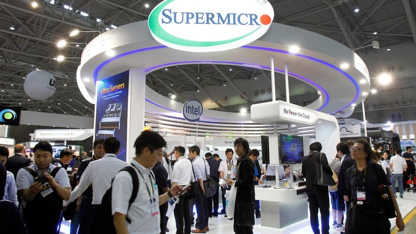 FILE - Visitors walk past a Super Micro Computer Inc. booth at the Computex Taipei exhibition in Taipei, Taiwan, June 5, 2018. (AP Photo/Chiang Ying-ying, File) CAMH406