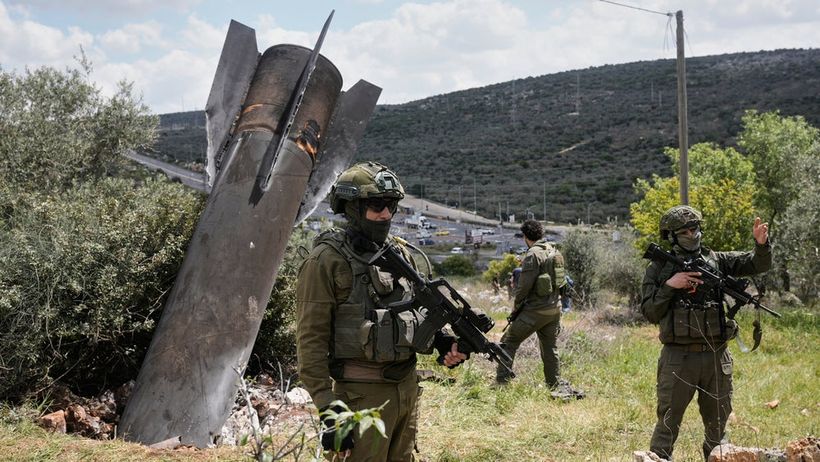 Israeli soldiers secure the site where an Iranian missile wreckage landed in the West Bank village of Kifl Haris Tuesday, March 24, 2026. (AP Photo/Majdi Mohammed) XOB36