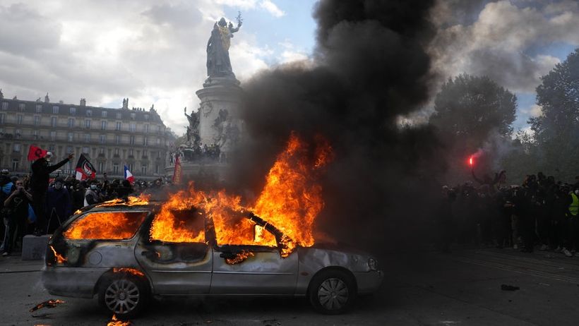 A car burns at Republique square during a protest against rising living costs, joining students' grievances, in Paris, Saturday, Oct. 17, 2026. (AP Photo/Thibault Camus)
