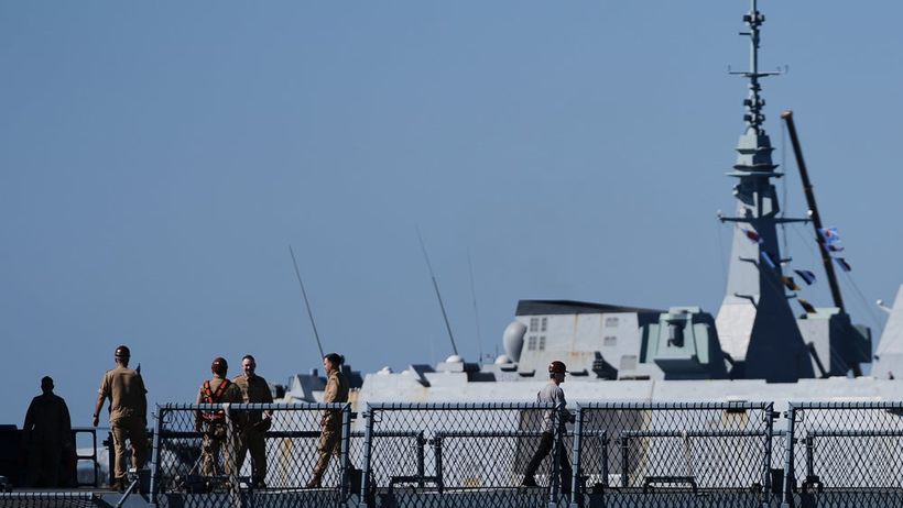 A French frigate enters the port behind sailors walking on the German UNIFIL ship FGS Nordrhein-Westfalen docked at the port of Limassol, Cyprus, Tuesday, March 10, 2026. (AP Photo/Petros Karadjias) XPK101